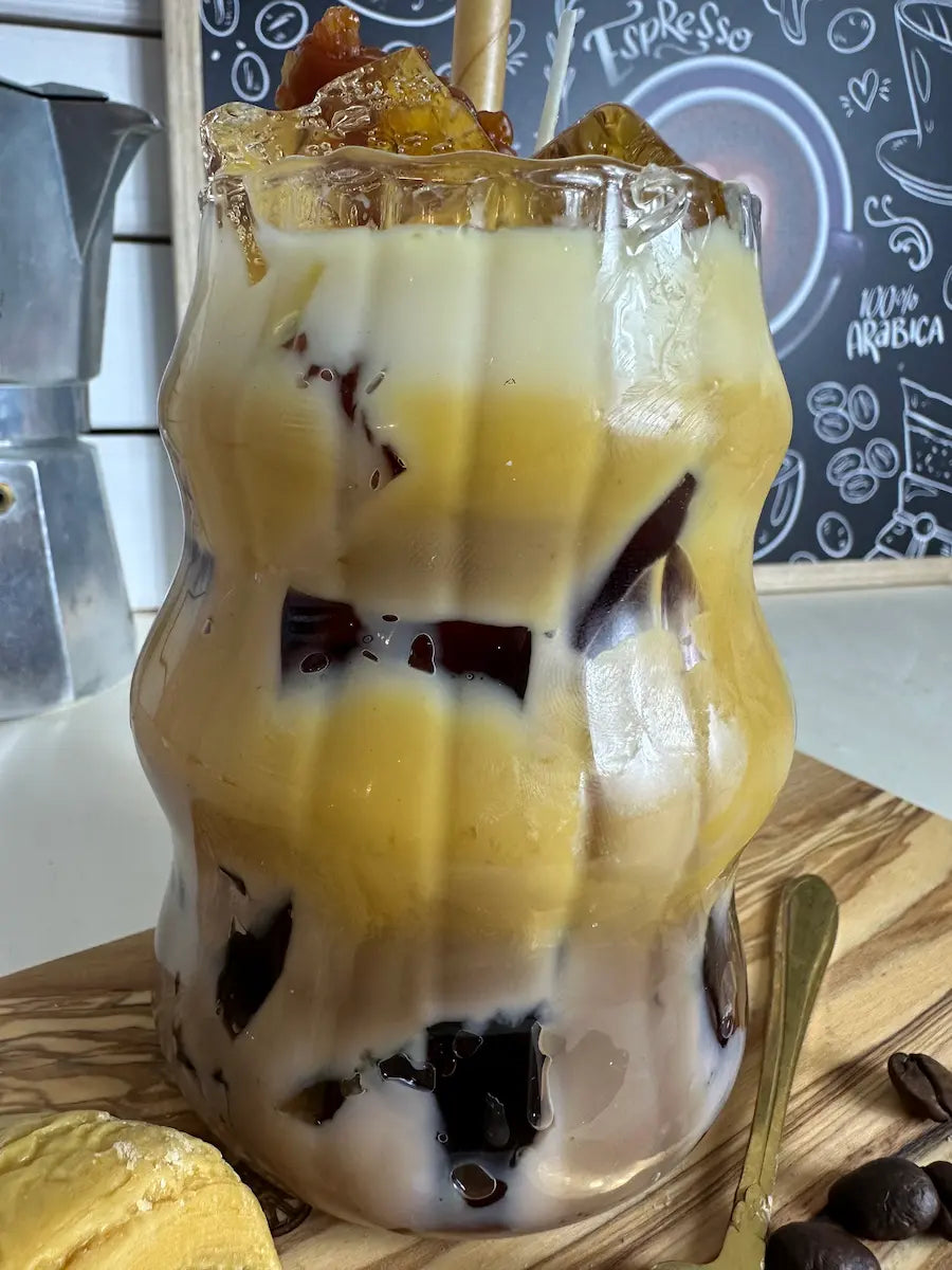 Detailansicht der Latte-Macchiato-Kerze mit cremigem Wachs, Karamell-Drip und knuspriger Dekoration – kramMITcharme