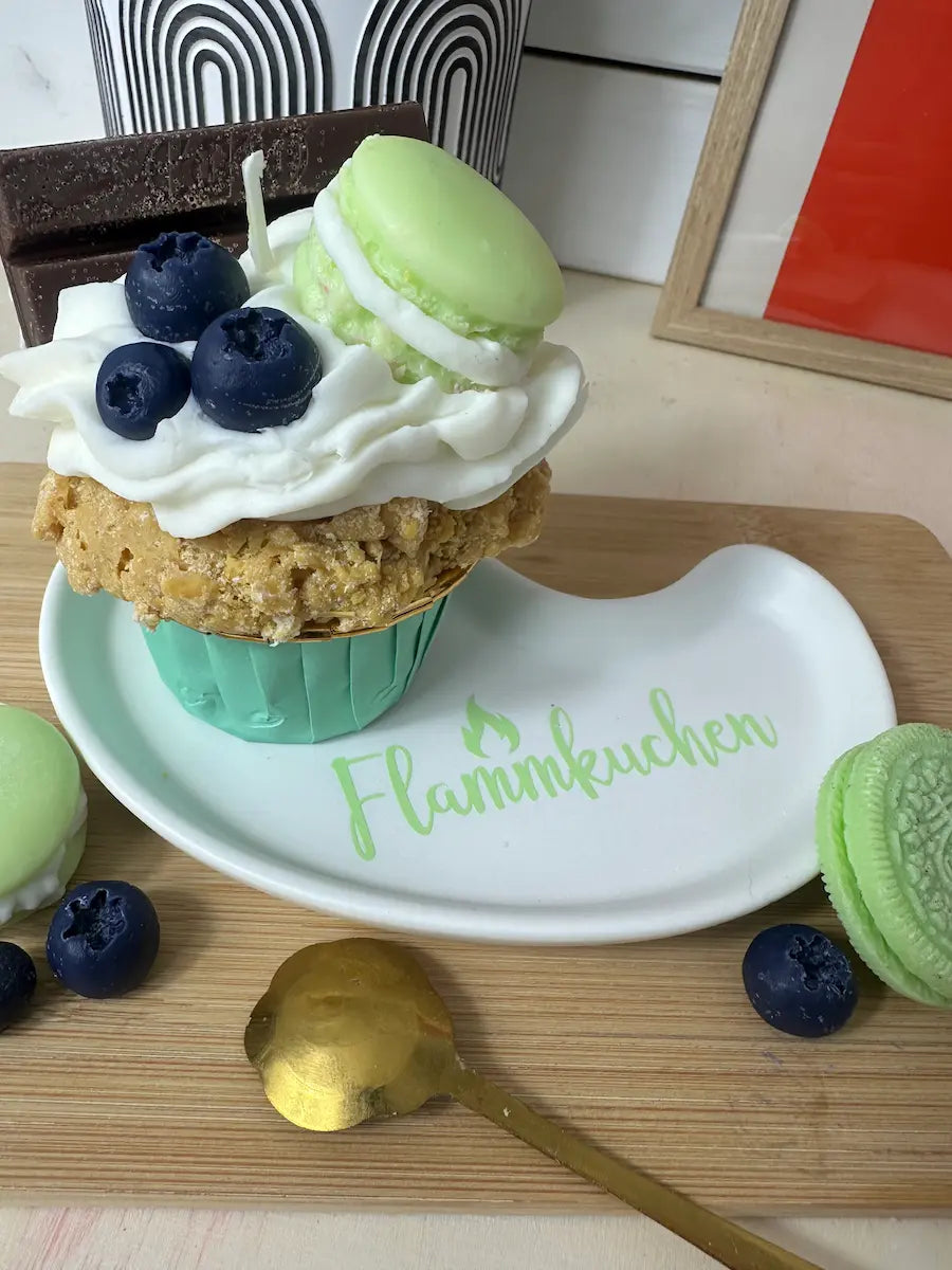 Duftkerze „Flammkuchen Cupcake“ auf Teller mit Schriftzug Flammkuchen, verziert mit Blaubeeren – kramMITcharme