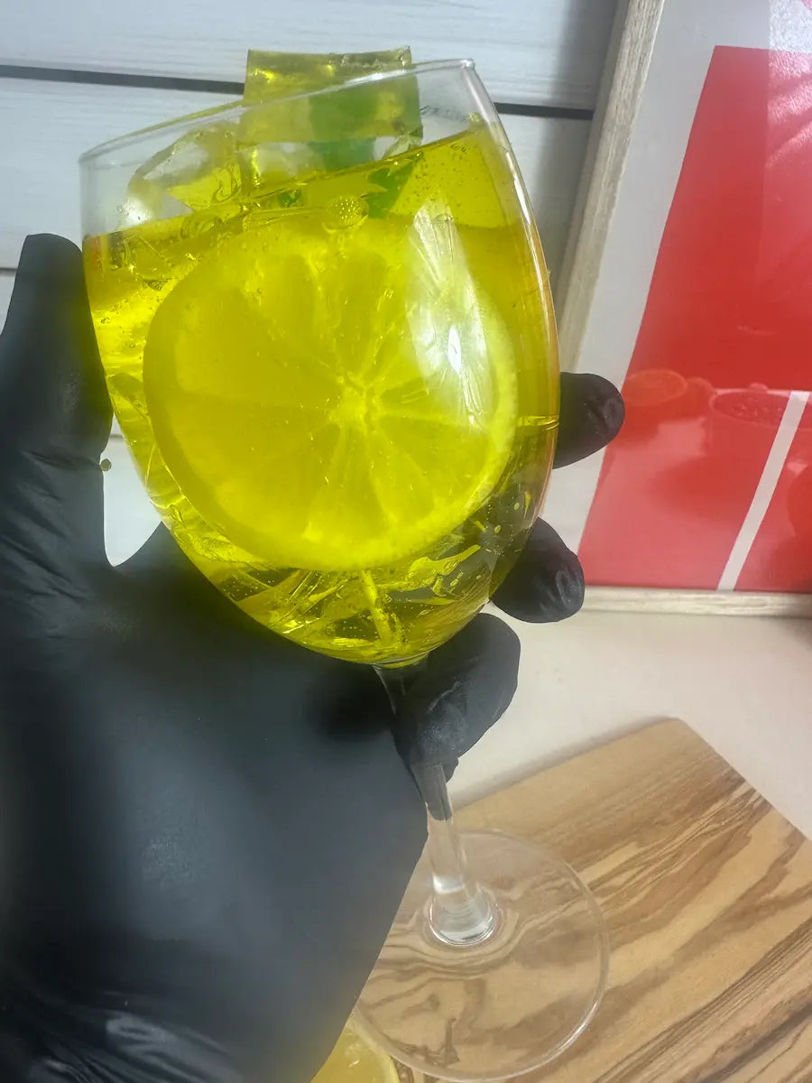 Handaufnahme der Duftkerze „Limoncello Spritz“ mit frischer Zitronenoptik im Glas – kramMITcharme